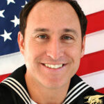 A headshot photo of Chris Campbell in his Navy Uniform